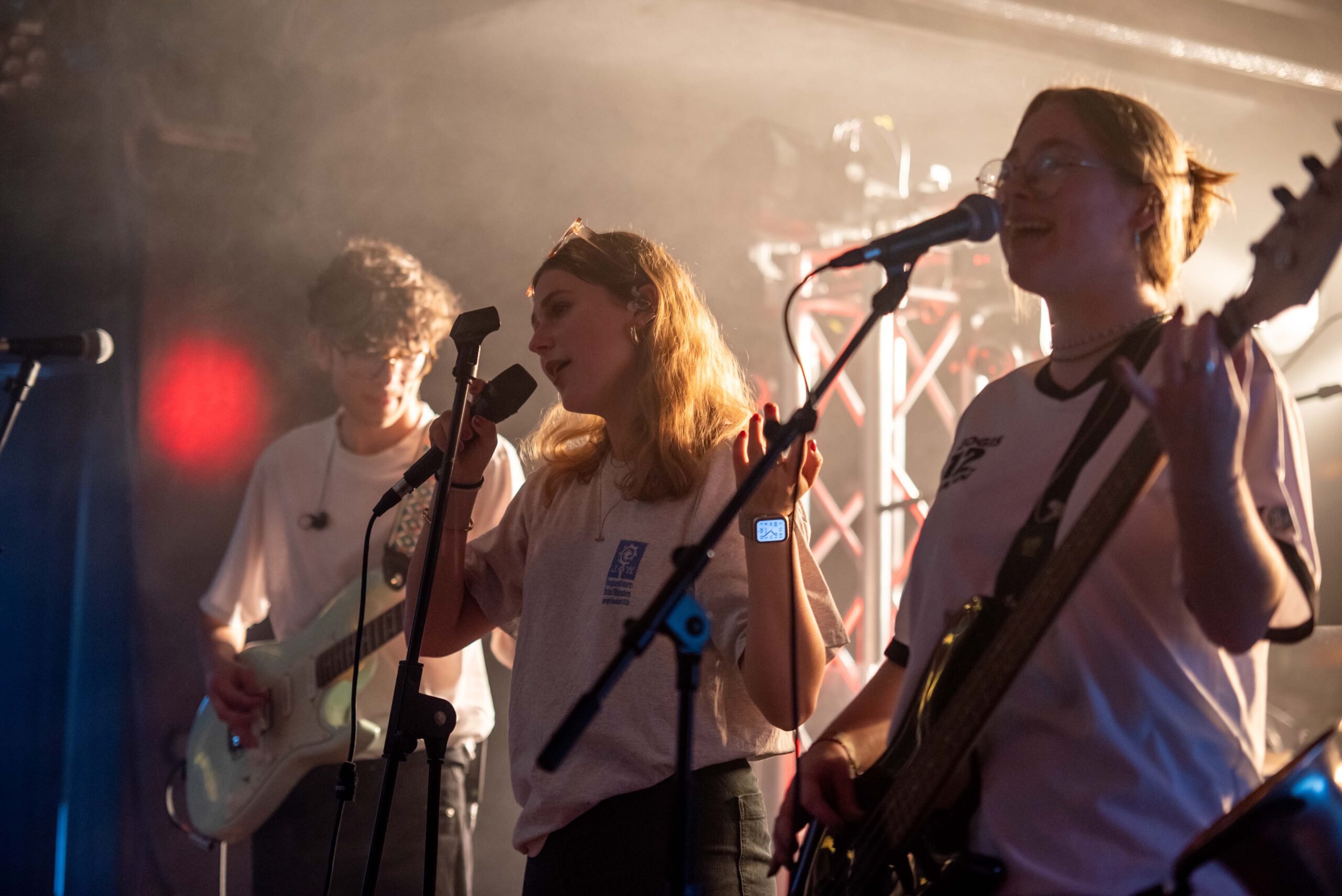 a group of people singing on a stage