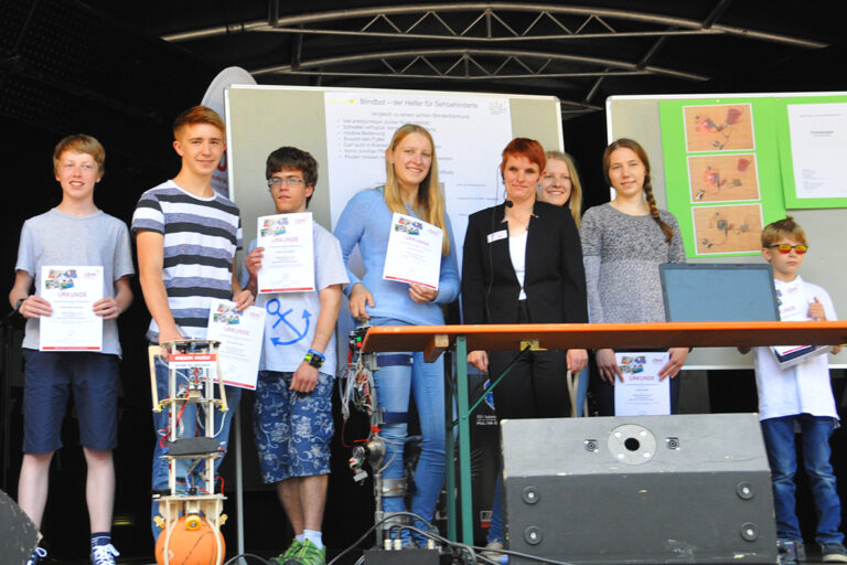 a group of people standing in front of a stage